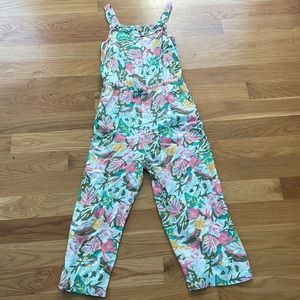 white romper/jumper with pink and green flowers and leaves.